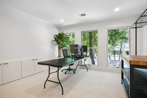 a hallway with sink and wooden floor