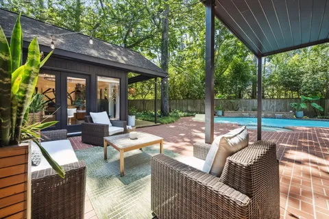 a view of a porch with furniture and garden