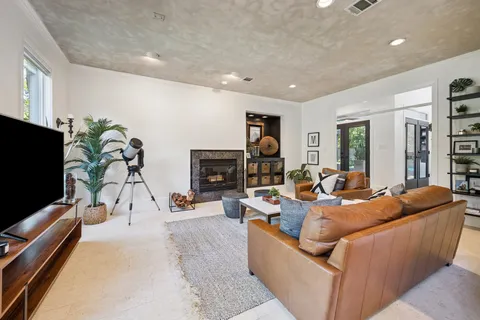 a living room with fireplace furniture and a flat screen tv