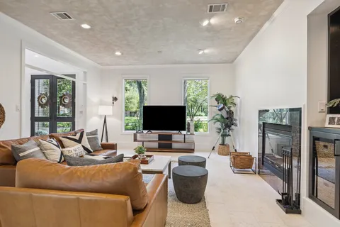 a living room with furniture flat screen tv and a fireplace