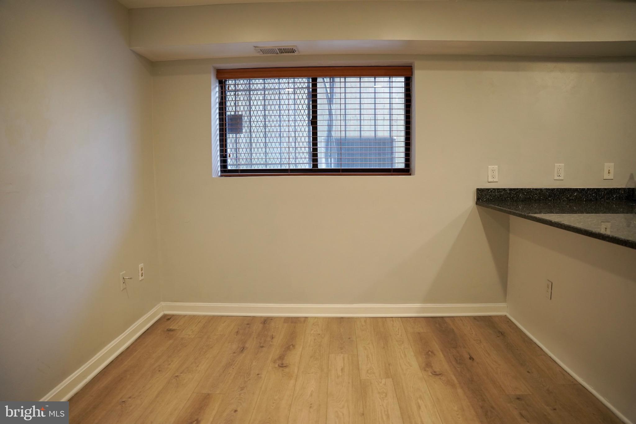 1321 Fairmont Street Northwest, Unit 3 Washington, DC 20009 - Photo 3 of 13 a view of an empty room with wooden floor and a window