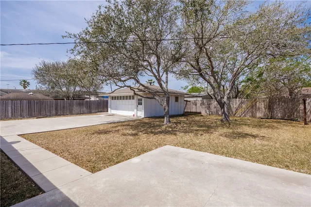 a view of a yard with a house and tree
