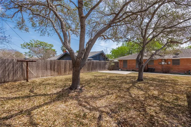 a backyard of a house with lots of green space