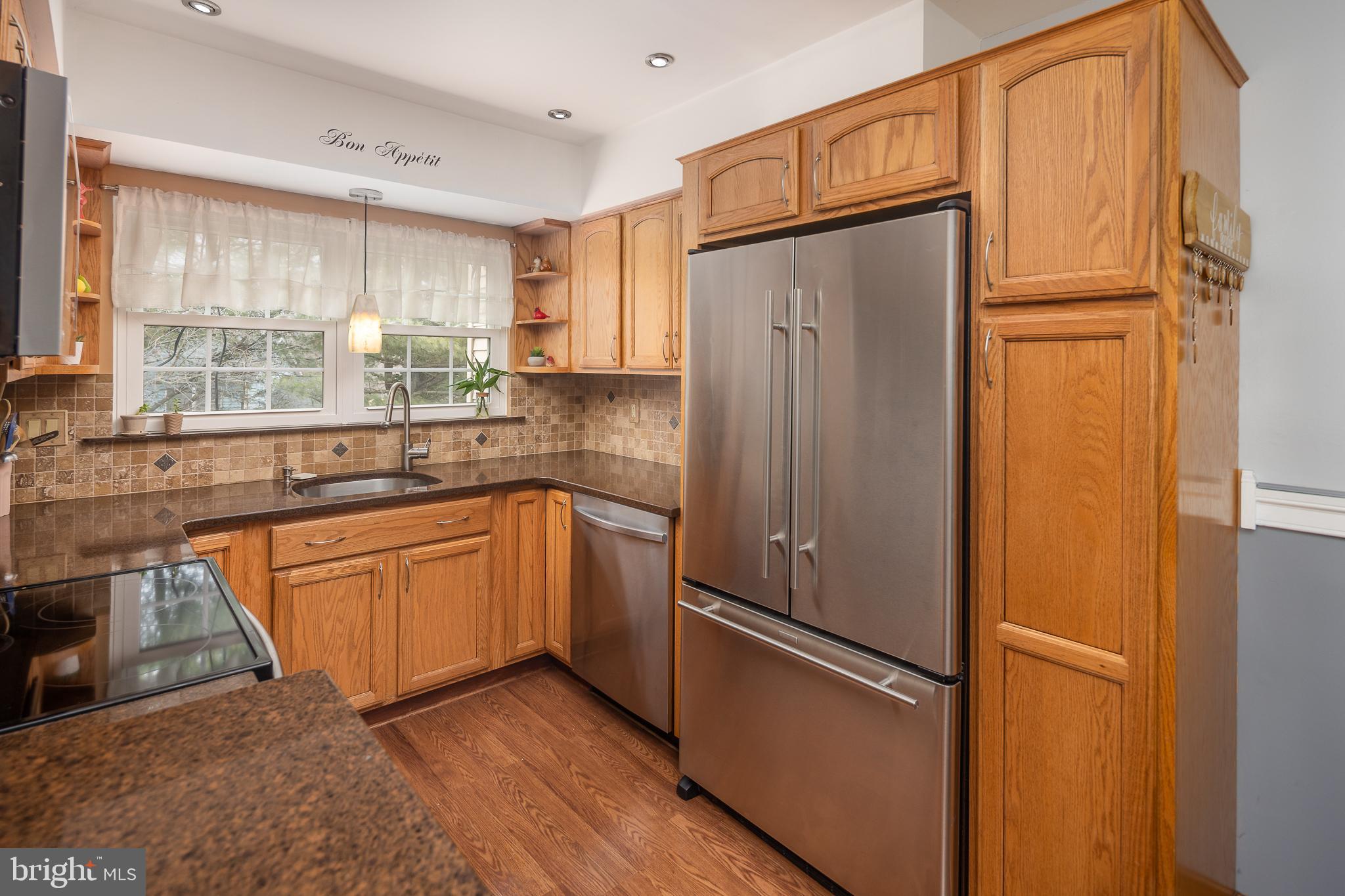 9210 Caspian Way, Unit 302 Manassas, VA 20110 - Photo 12 of 40 a kitchen with stainless steel appliances granite countertop a refrigerator and a sink