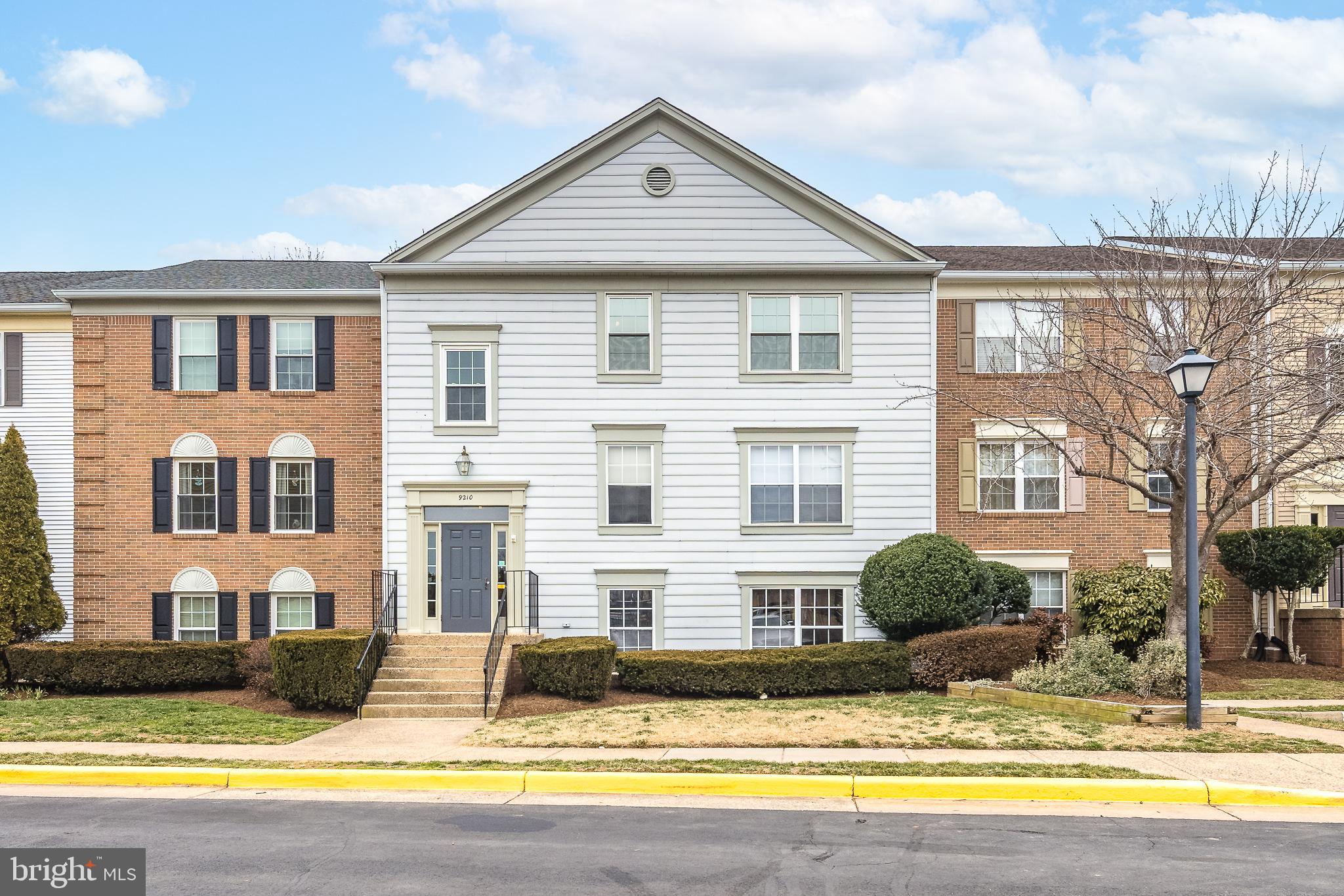 9210 Caspian Way, Unit 302 Manassas, VA 20110 - Photo 2 of 40 a front view of a house with swimming pool and porch