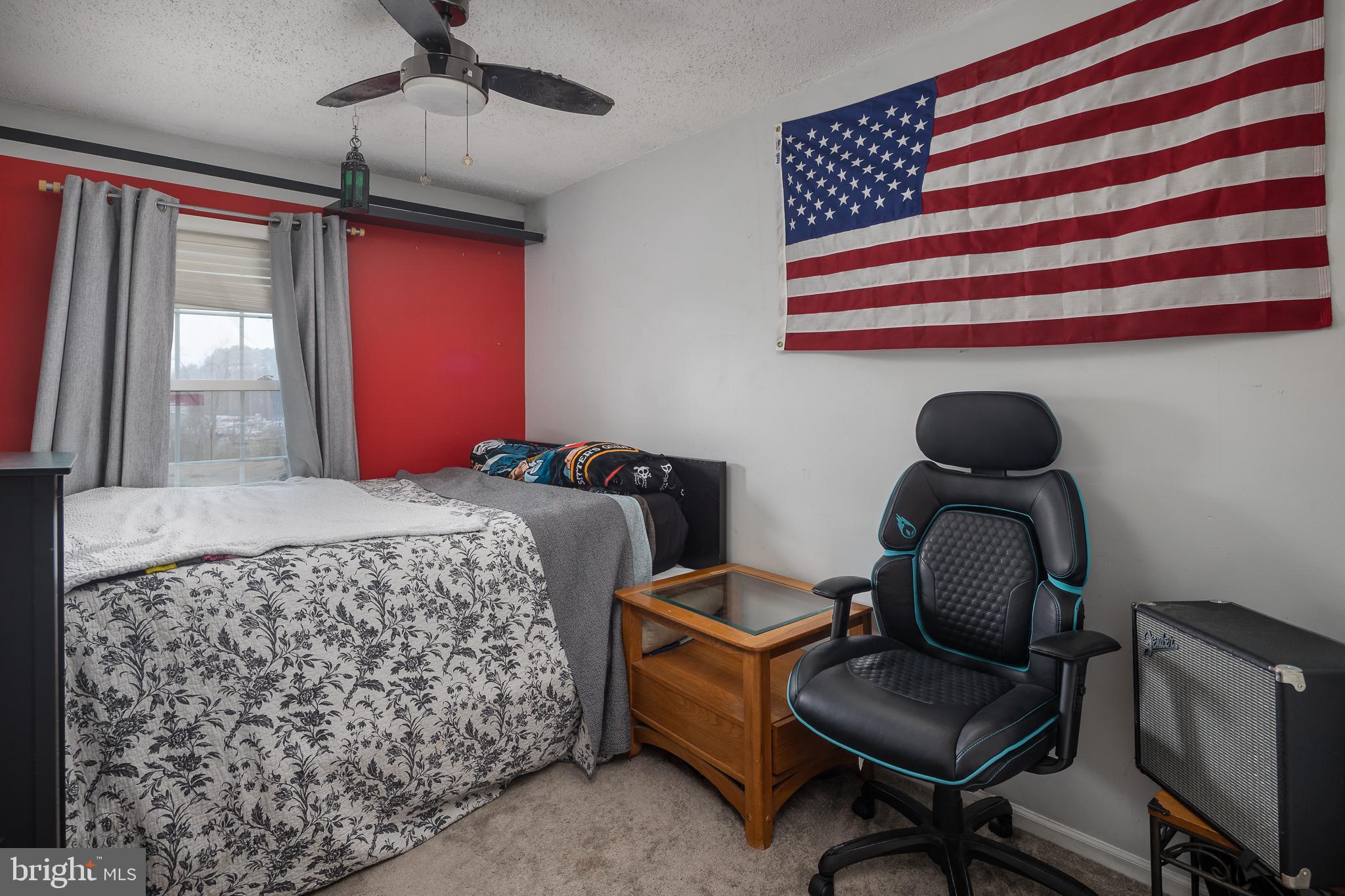 9210 Caspian Way, Unit 302 Manassas, VA 20110 - Photo 21 of 40 a bedroom with a bed chair and window