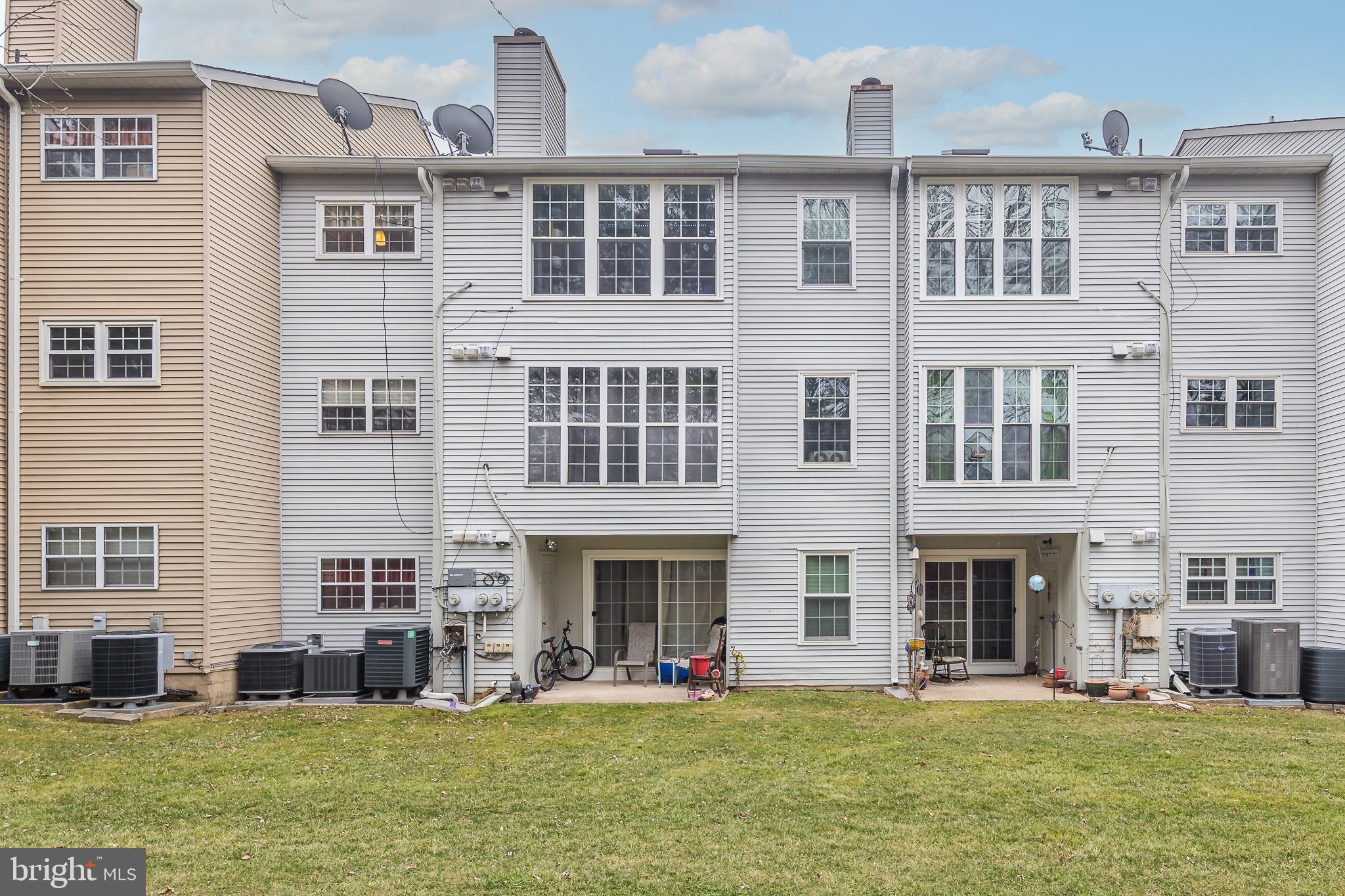 9210 Caspian Way, Unit 302 Manassas, VA 20110 - Photo 24 of 40 a large building with a swimming pool in front of it