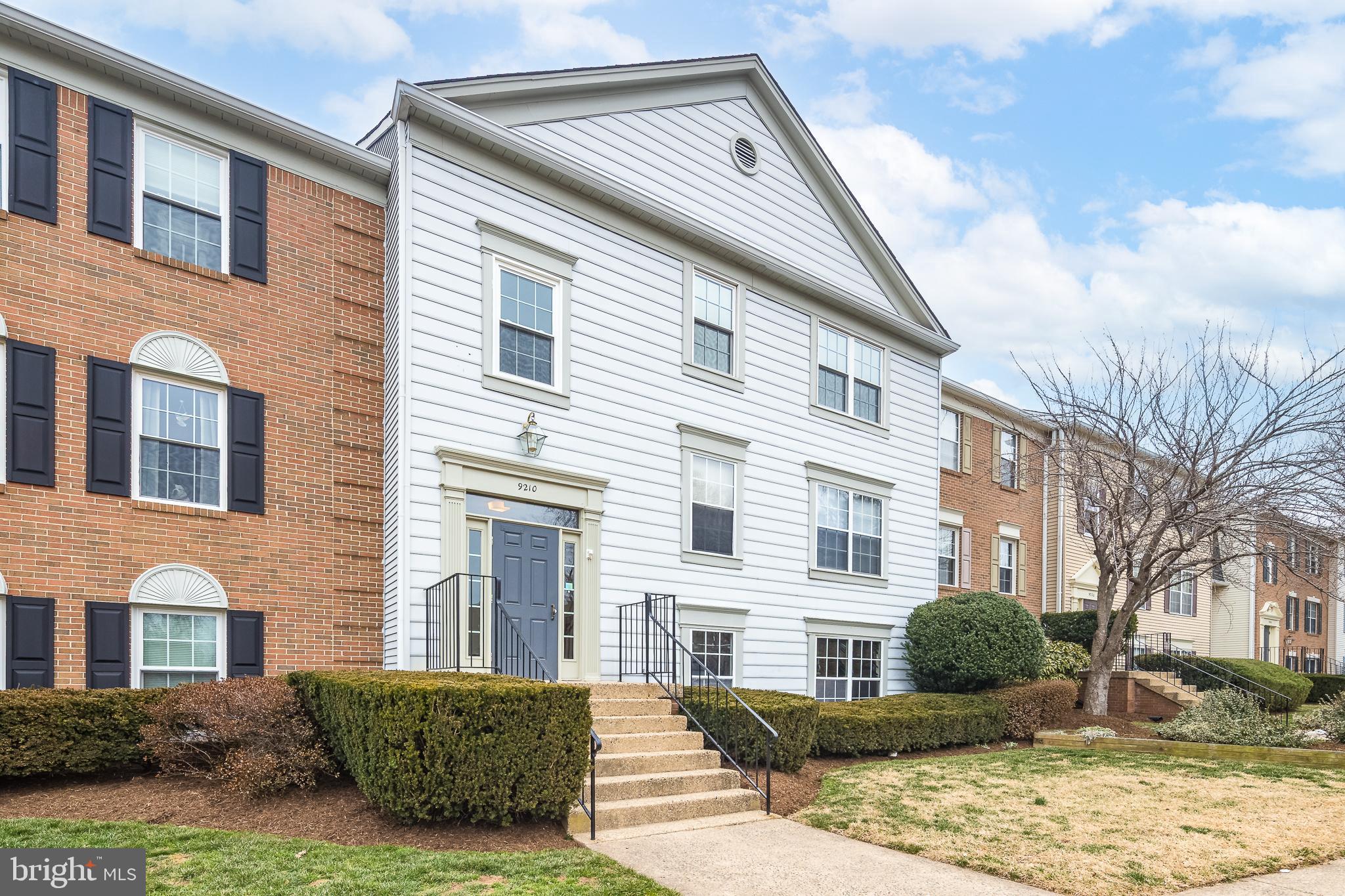 9210 Caspian Way, Unit 302 Manassas, VA 20110 - Photo 3 of 40 a front view of a house with a yard