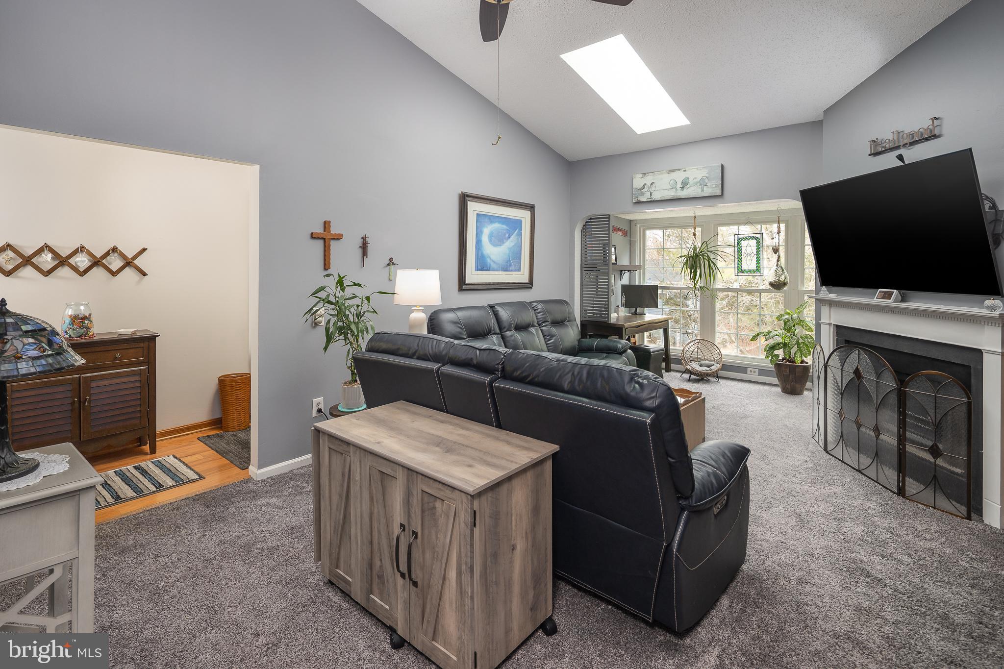9210 Caspian Way, Unit 302 Manassas, VA 20110 - Photo 7 of 40 a living room with furniture a flat screen tv and a fireplace