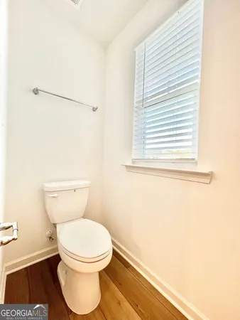a white toilet sitting next to a window