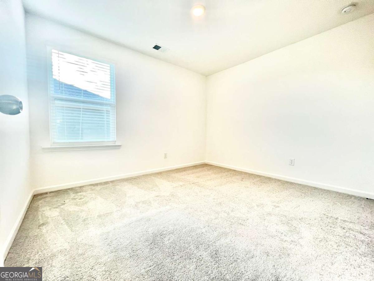 1529 Haypatch Lane Loganville, GA 30052 - Photo 17 of 24 an empty room with a window