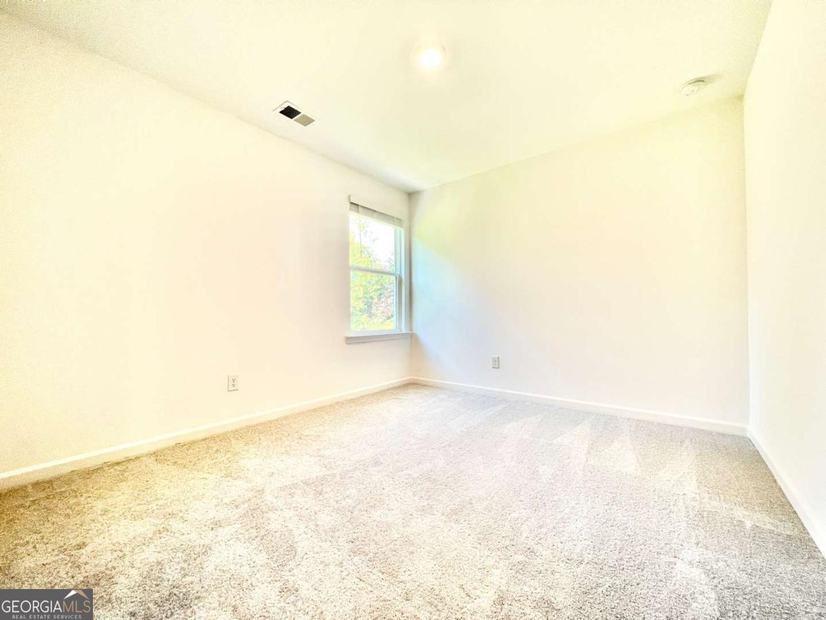 1529 Haypatch Lane Loganville, GA 30052 - Photo 22 of 24 a view of empty room with wooden floor