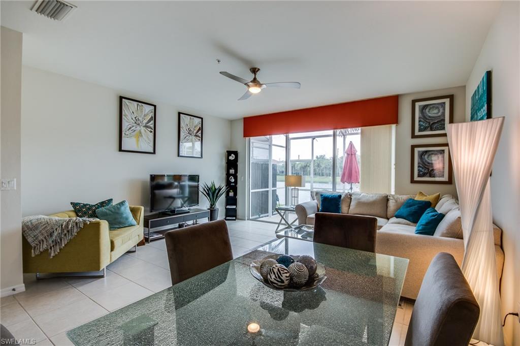16211 Ravina Way, Unit 18 Naples, FL 34110 - Photo 11 of 25 a living room with furniture fireplace and a large window