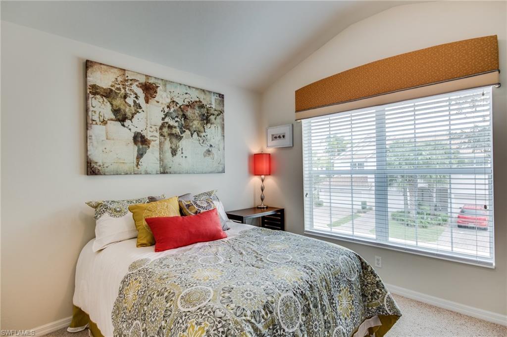 16211 Ravina Way, Unit 18 Naples, FL 34110 - Photo 19 of 25 a bedroom with bed and a large window
