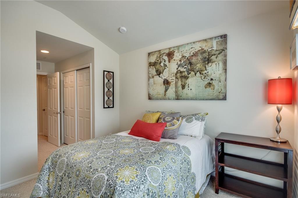 16211 Ravina Way, Unit 18 Naples, FL 34110 - Photo 20 of 25 a bedroom with a bed and a painting on the wall