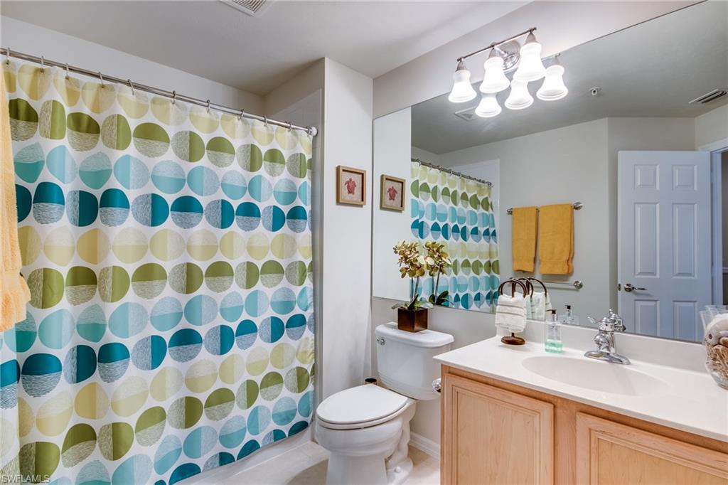 16211 Ravina Way, Unit 18 Naples, FL 34110 - Photo 21 of 25 a bathroom with a sink toilet and shower