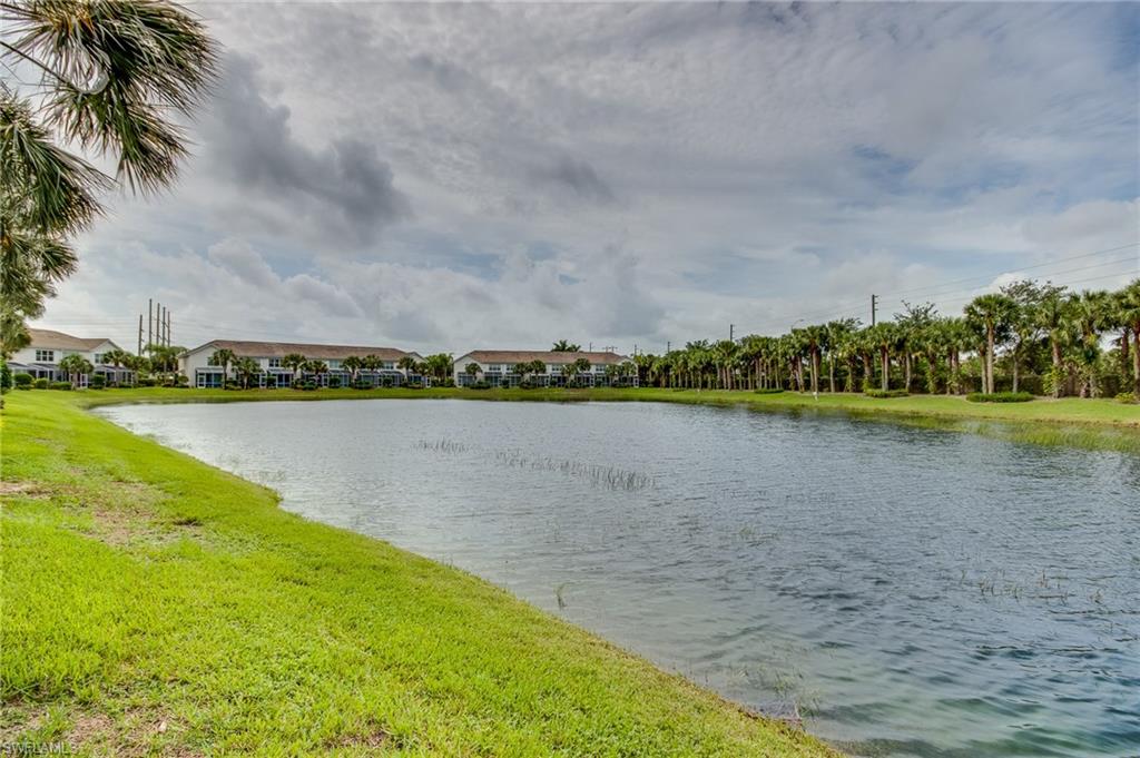 16211 Ravina Way, Unit 18 Naples, FL 34110 - Photo 25 of 25 a view of a lake with houses in the background