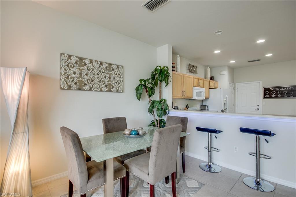 16211 Ravina Way, Unit 18 Naples, FL 34110 - Photo 8 of 25 a view of a dining room with furniture
