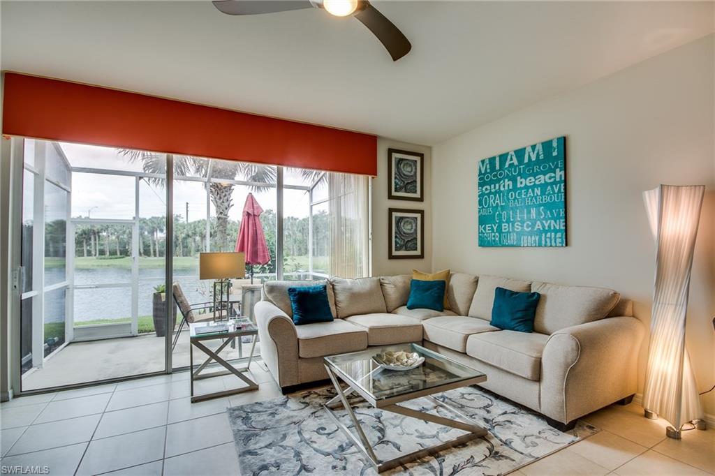 16211 Ravina Way, Unit 18 Naples, FL 34110 - Photo 9 of 25 a living room with furniture and a floor to ceiling window