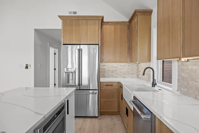 a kitchen with a sink and a refrigerator
