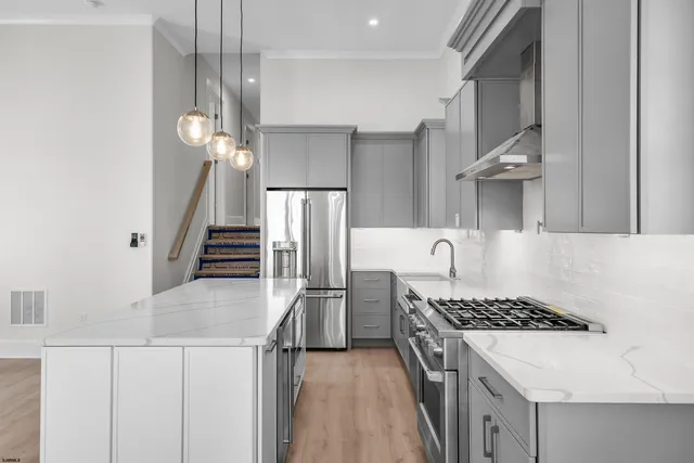 a kitchen with a sink cabinets and stainless steel appliances