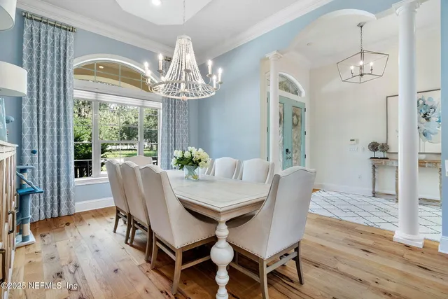 a kitchen with kitchen island white cabinets and stainless steel appliances