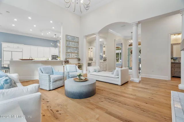 a kitchen with white cabinets and sink