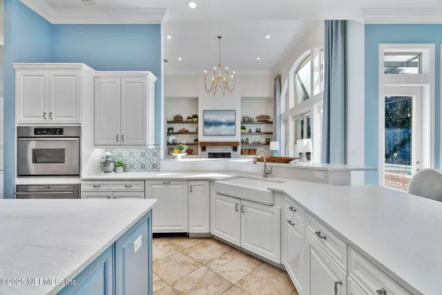 a dining room with furniture a chandelier and fireplace