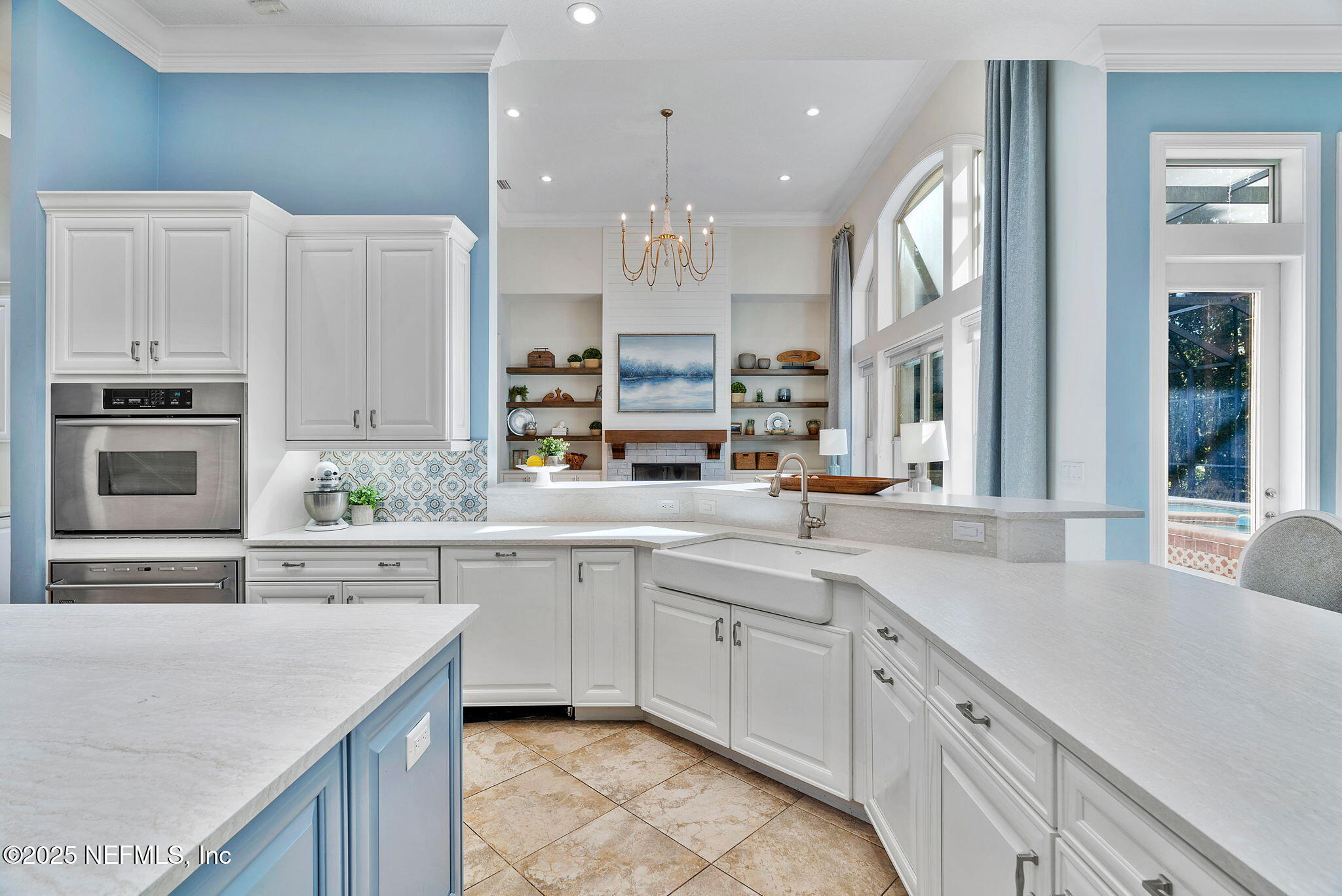 1141 Popolee Road St. Johns, FL 32259 - Photo 17 of 79 a kitchen with kitchen island white cabinets and stainless steel appliances