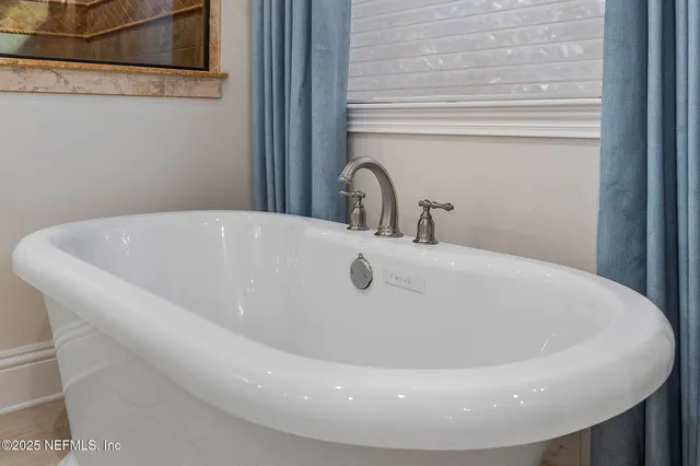a kitchen with cabinets appliances a sink and a window