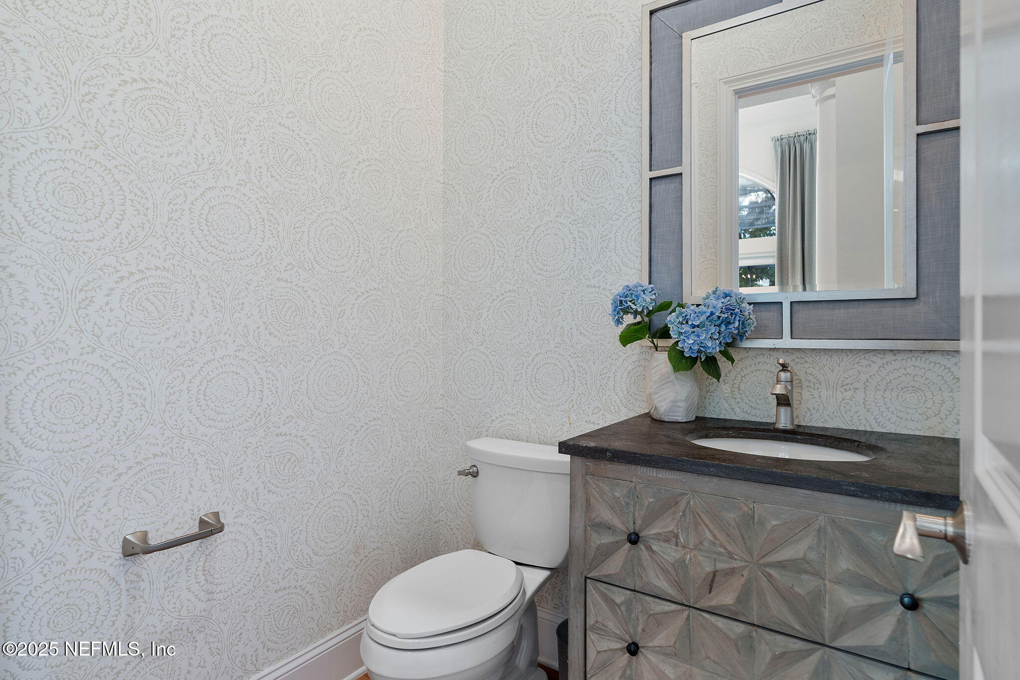 1141 Popolee Road St. Johns, FL 32259 - Photo 42 of 79 a bathroom with a sink a toilet and mirror