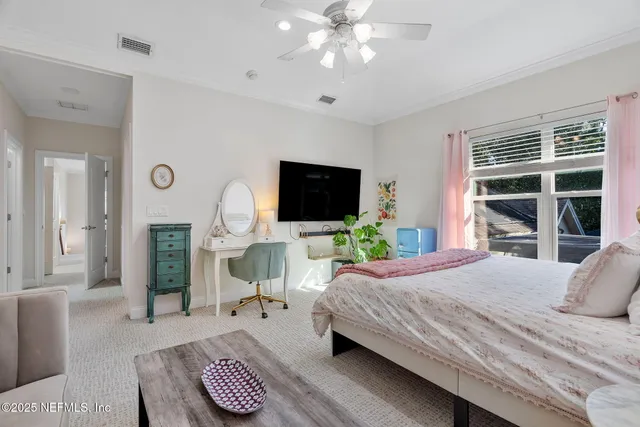 a living room with large window and furniture