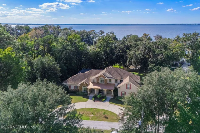 a aerial view of a house with a yard and sitting area