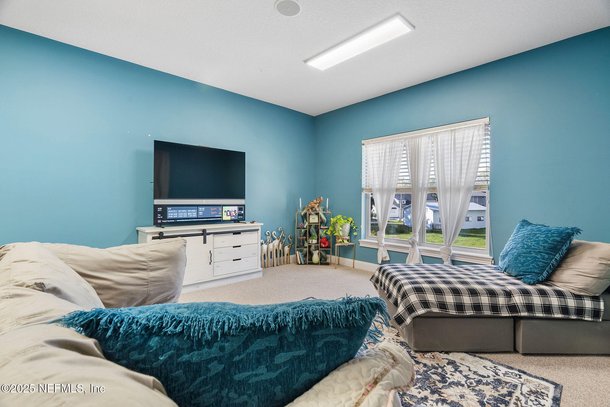1141 Popolee Road St. Johns, FL 32259 - Photo 57 of 79 a living room with furniture and a flat screen tv