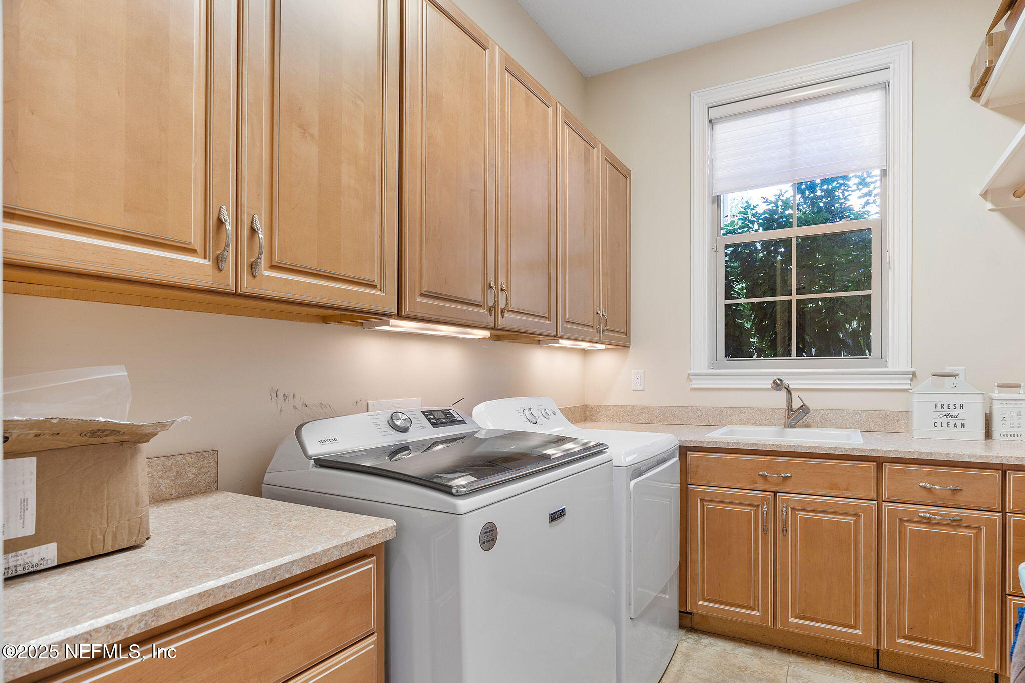 1141 Popolee Road St. Johns, FL 32259 - Photo 58 of 79 a kitchen with cabinets appliances a sink and a window