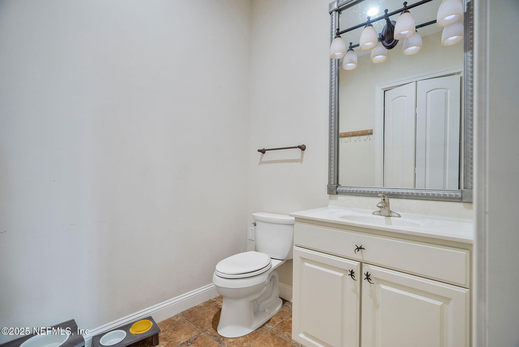 1141 Popolee Road St. Johns, FL 32259 - Photo 72 of 79 a bathroom with a toilet a sink and mirror