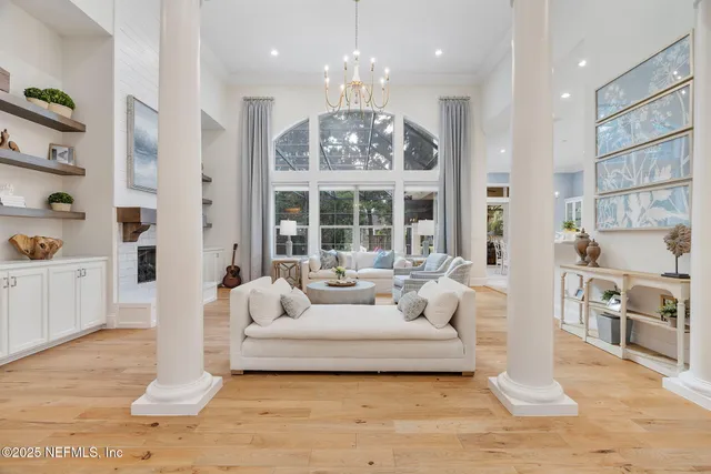 a living room with furniture and a chandelier