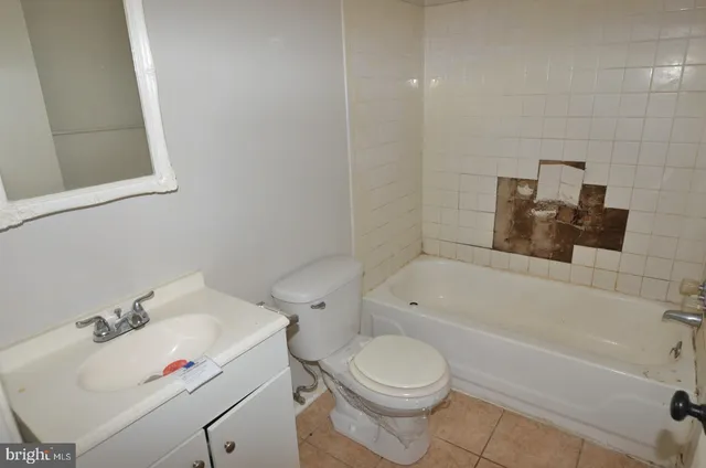 a bathroom with a sink a toilet and bathtub
