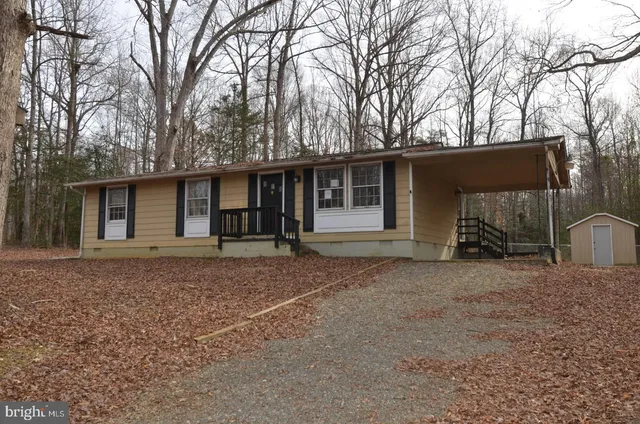 a view of a house with a yard and garage
