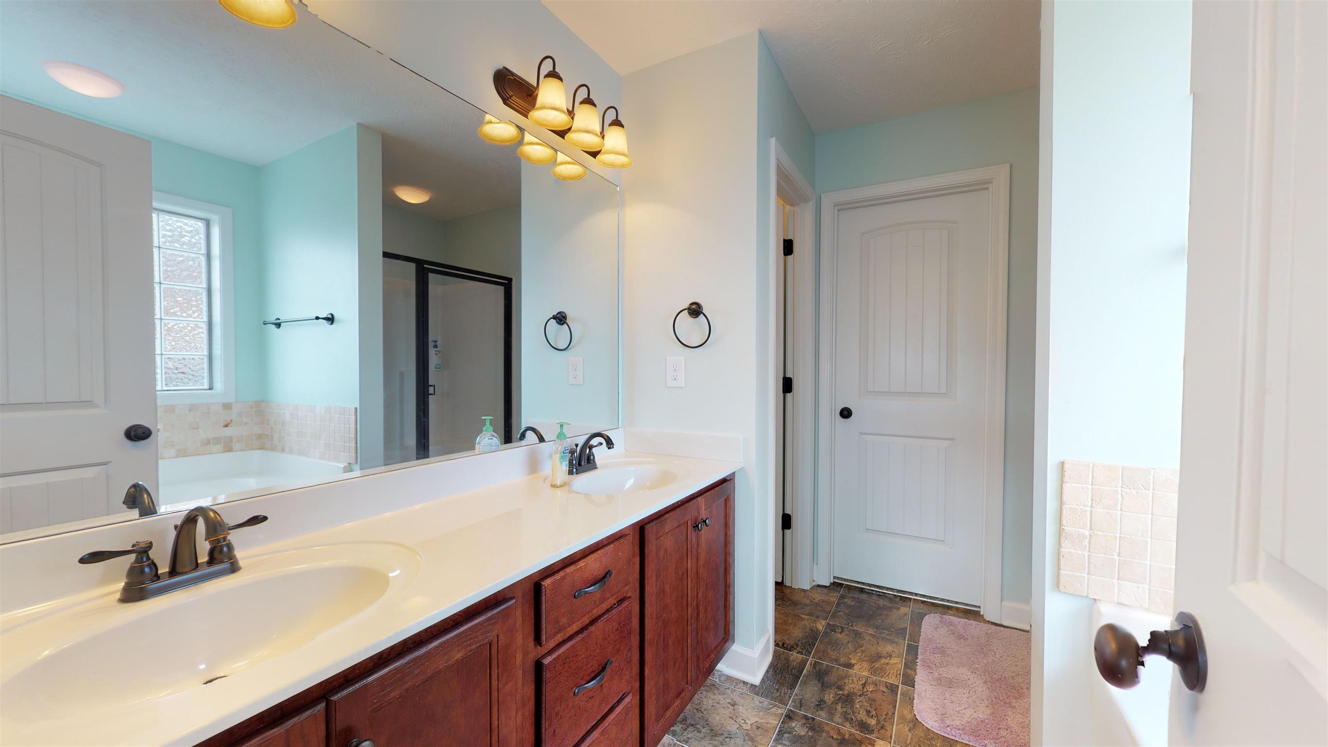 108 Riddick Court Murfreesboro, TN 37127 - Photo 7 of 14 Master bath with double vanities and separate shower and tub. Walk-in closet just off the bath