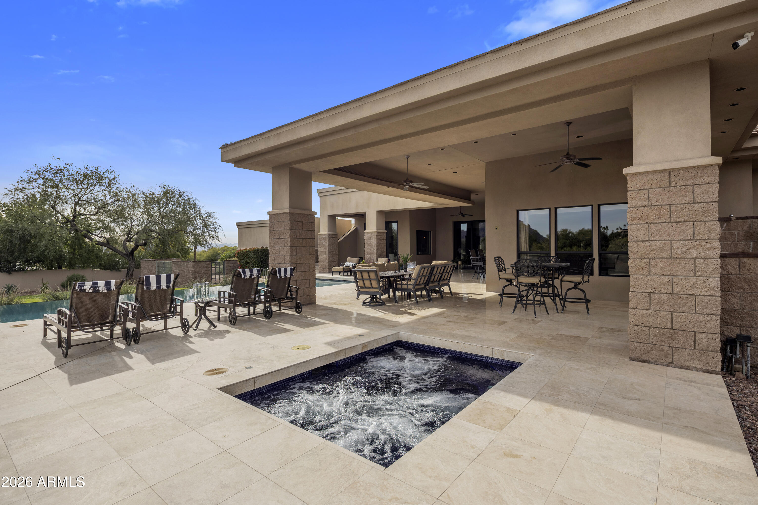 6109 North Palo Cristi Road Paradise Valley, AZ 85253 - Photo 13 of 76 a view of a patio with dining table and chairs and potted plants