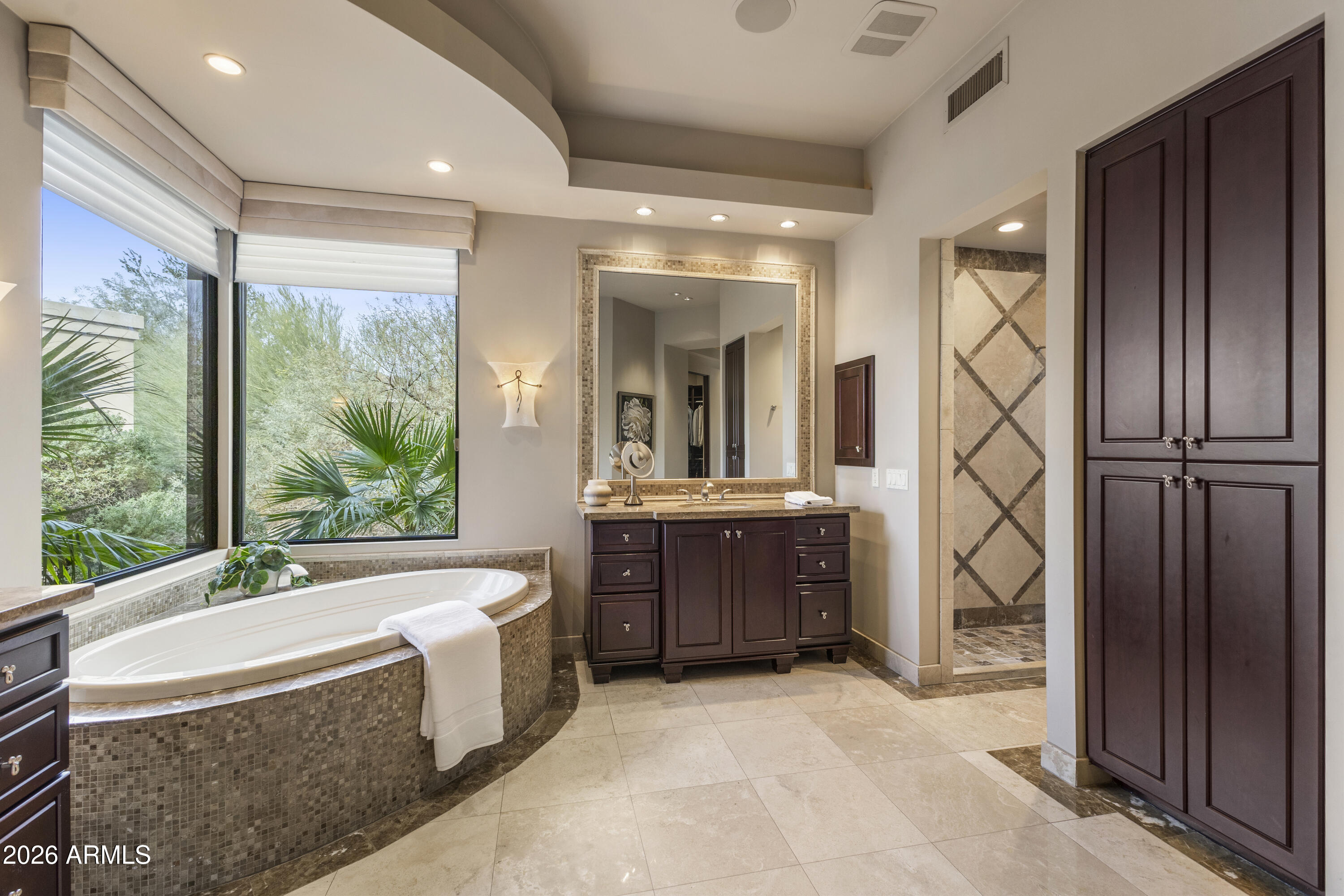 6109 North Palo Cristi Road Paradise Valley, AZ 85253 - Photo 26 of 76 a bathroom with a tub sink and mirror