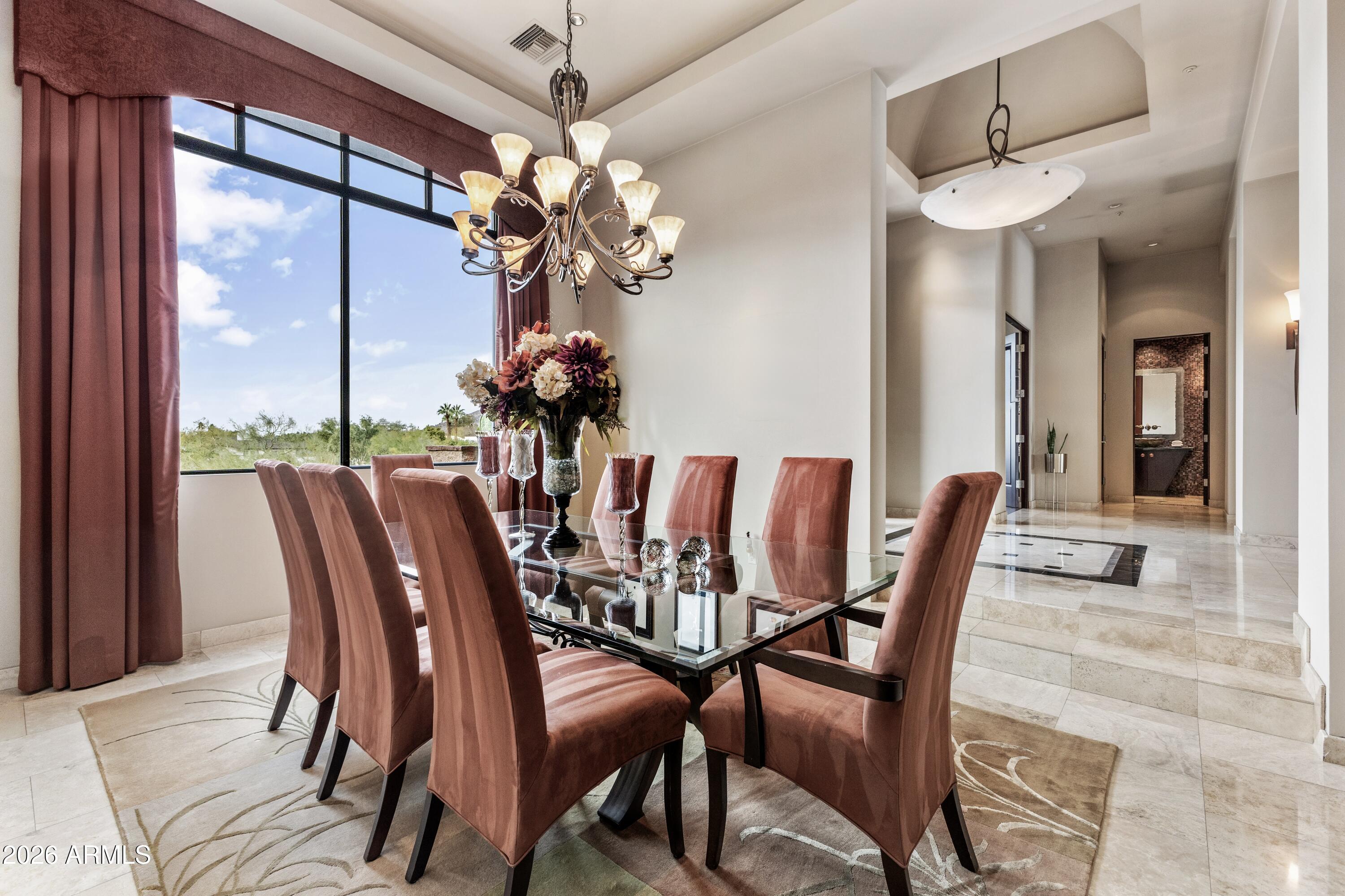 6109 North Palo Cristi Road Paradise Valley, AZ 85253 - Photo 35 of 76 a view of a dining room with furniture wooden floor and chandelier