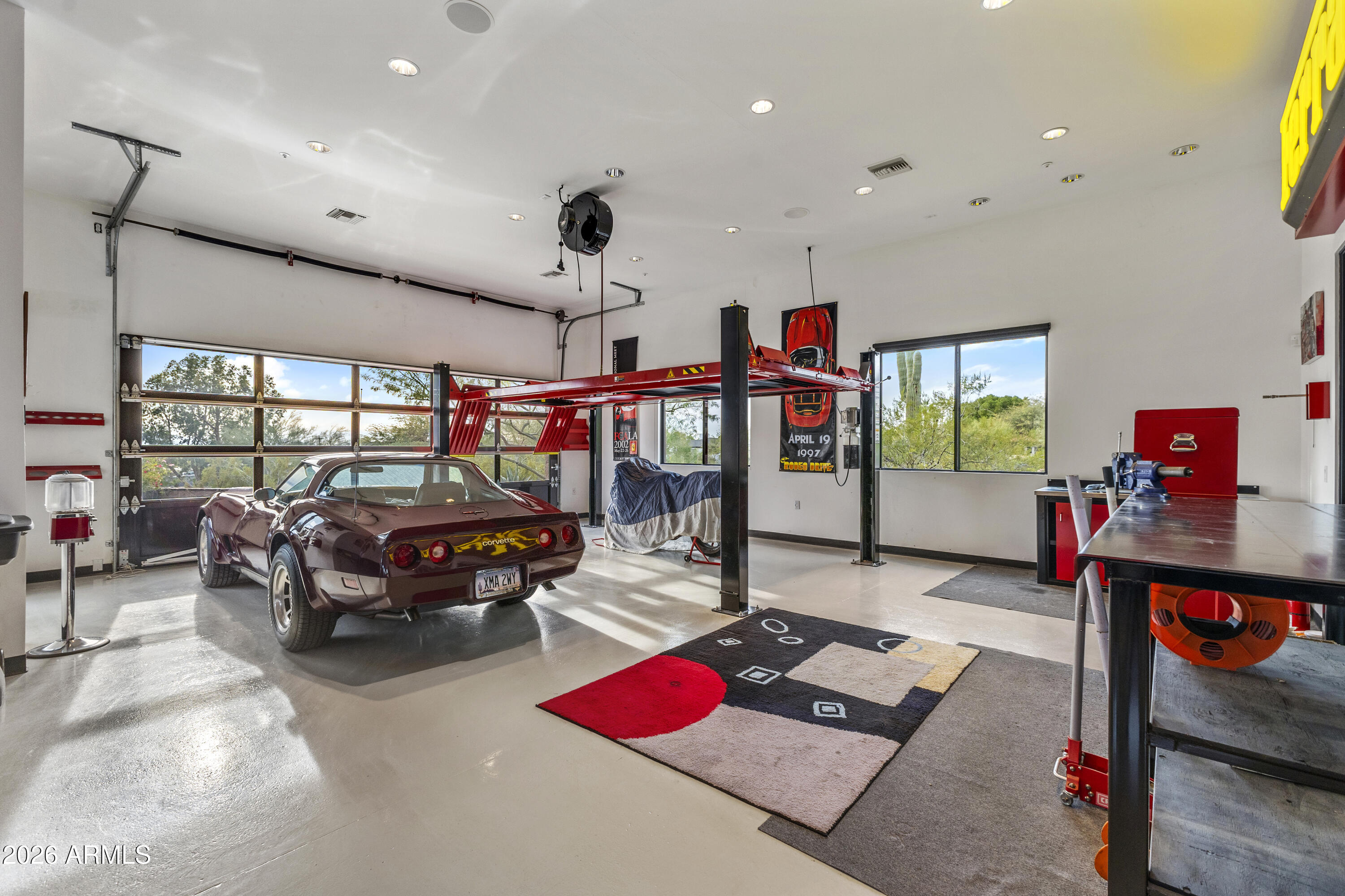 6109 North Palo Cristi Road Paradise Valley, AZ 85253 - Photo 41 of 76 a living room with furniture a flat screen tv and a floor to ceiling window