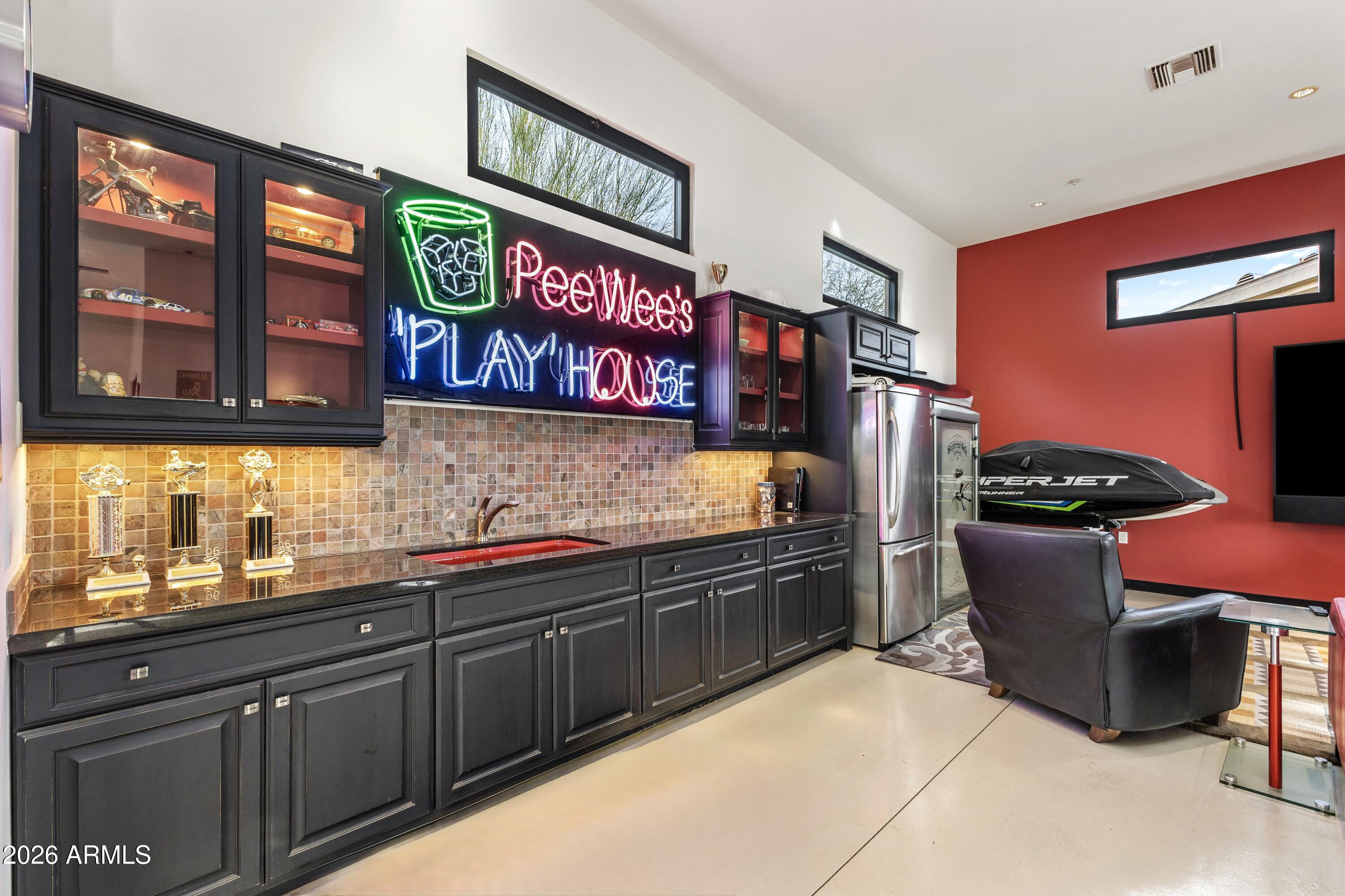 6109 North Palo Cristi Road Paradise Valley, AZ 85253 - Photo 45 of 76 a kitchen with stainless steel appliances granite countertop a sink and a wooden cabinets
