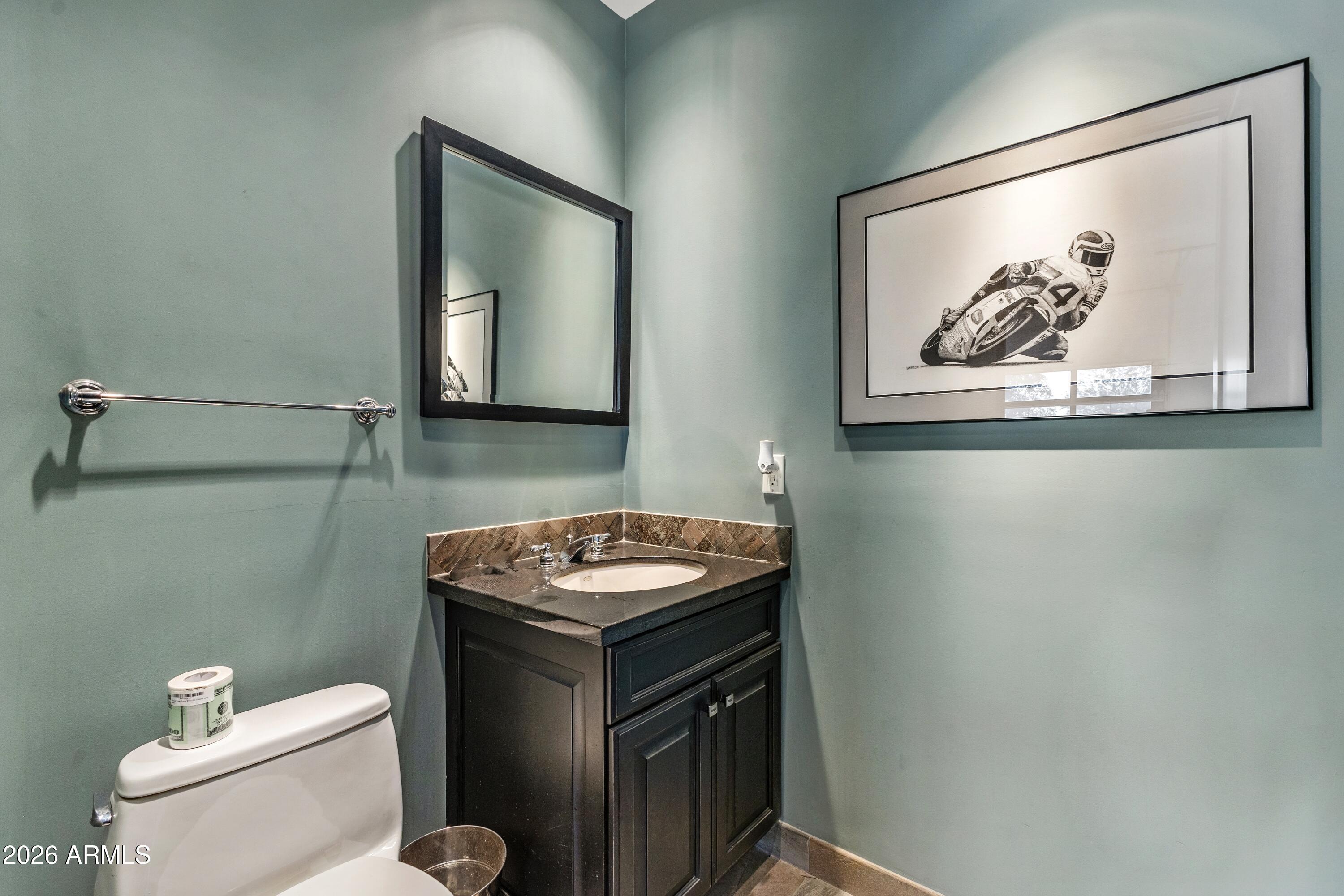 6109 North Palo Cristi Road Paradise Valley, AZ 85253 - Photo 47 of 76 a bathroom with a toilet a sink and mirror