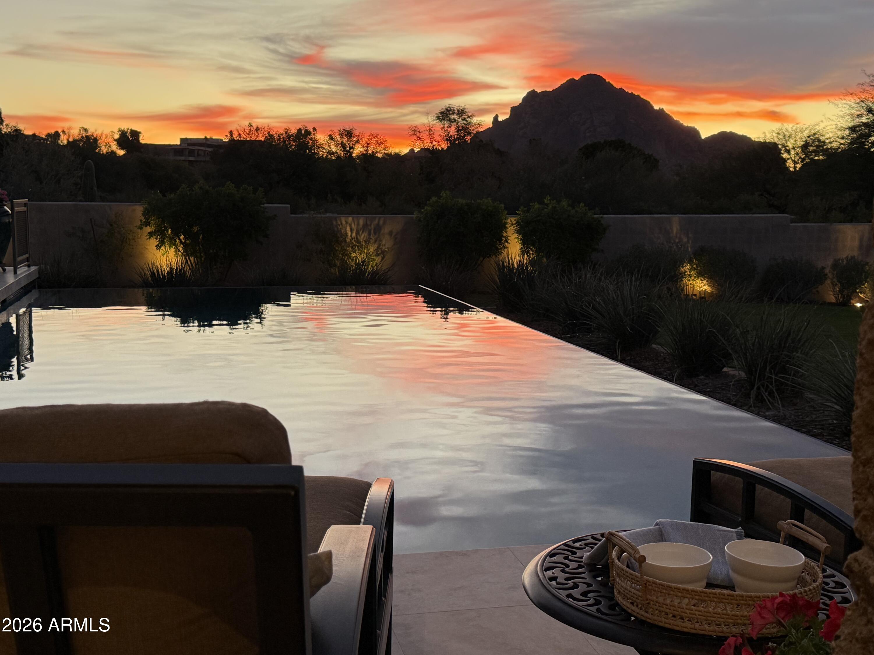 6109 North Palo Cristi Road Paradise Valley, AZ 85253 - Photo 10 of 76 a backyard of a house with table and chairs & fire pit