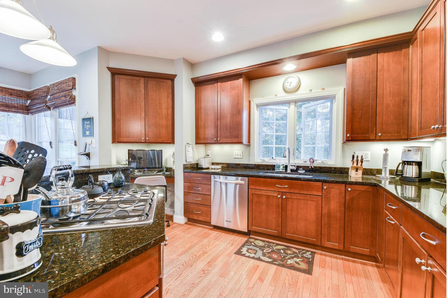 1500 Grace Church Road Silver Spring, MD 20910 - Photo 11 of 30 a kitchen with stainless steel appliances granite countertop sink stove top oven and cabinets