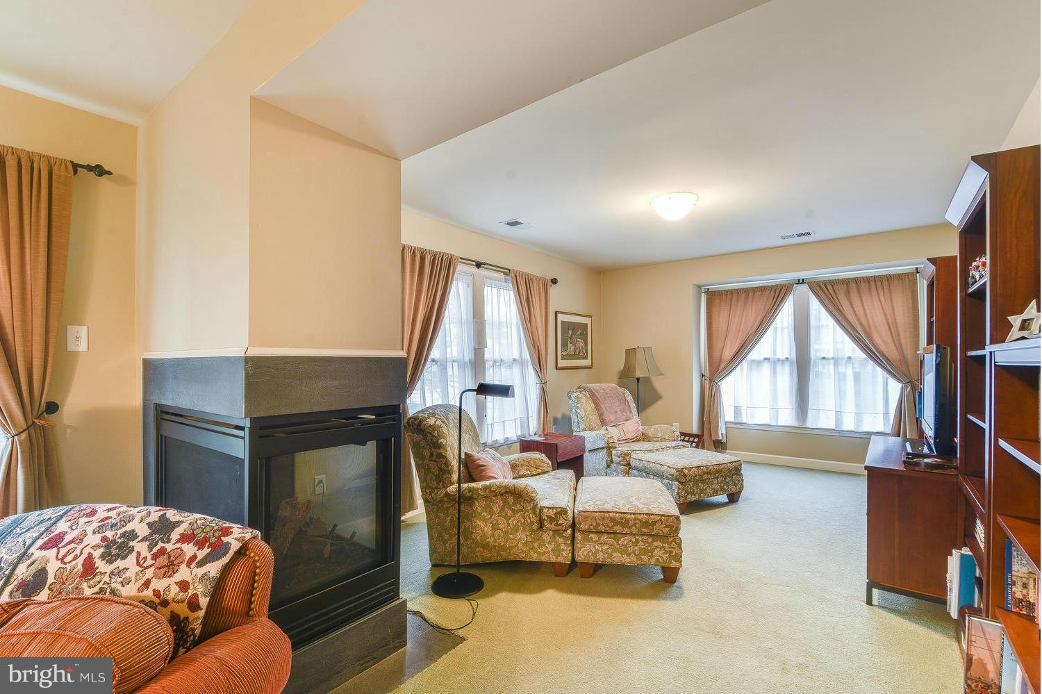 1500 Grace Church Road Silver Spring, MD 20910 - Photo 17 of 30 a living room with furniture a large window and a flat screen tv