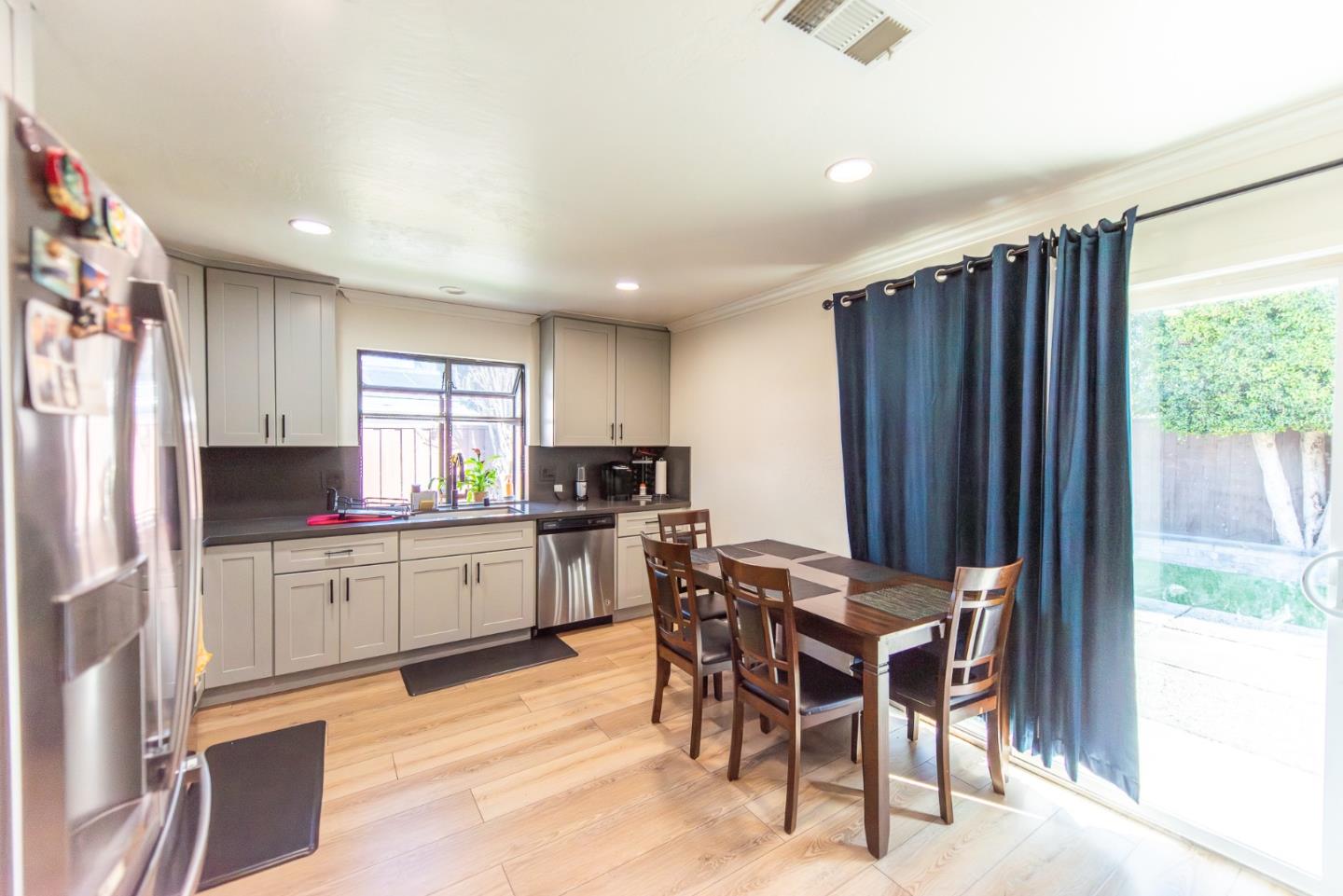 5798 Ribchester Court San Jose, CA 95123 - Photo 11 of 18 a kitchen with stainless steel appliances kitchen island granite countertop a refrigerator and cabinets
